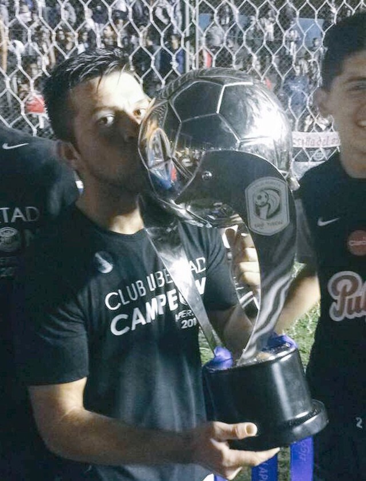 Báez besa el trofeo ganado con el Guma.